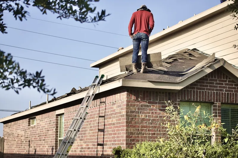 Professional roofer working on a residential roof in Blackwell